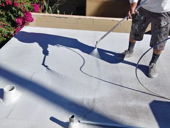 Applying a reflective roof coating
